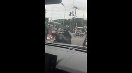 Tourist lies back on rented motorcycle while posing for selfies