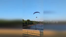 Paraglider strikes power line sending him plummeting into river