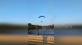 US: Paraglider Strikes Power Line And Crashes Into Red River In Shocking Video