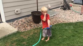 Three-Year-Old Keeps Spraying Himself With Water Hose