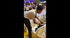 Friend gives graduate a sash of coffee sachets