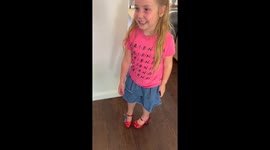 Little girl tries ruby slippers for the first time and wobbles while walking