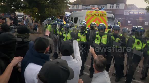 Protesters smash up police vans during clashes outside migrant hotel in Epping