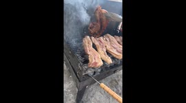 Tourists enjoy barbecue cooking traditional dishes on beach in Malta