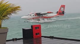 Sea plane battered by wind while taking off in choppy sea