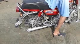 Motorcycle stuck in sandy mud in Pakistan