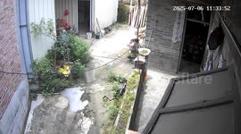 Pressure cooker explosion startles woman outside kitchen in Guangxi, China