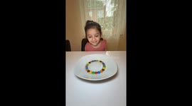 Little girl amazed by stunning M&Ms rainbow experiment that racked up 27m views