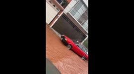 Truck splash soaks car through open window during road flood in Tepatitlán de Morelos, Mexico