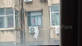 Wind foils housewife's attempt to retrieve clothes hanging outside window