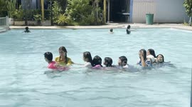 Thai kids having fun as the cool down from the very high July temperatures at Phetchabun, Thailand.