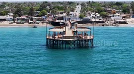 Wooden pier on the beach at Kino Bay in the municipality of Hermosillo, part of the Gulf of California, also known as the Sea of Cortez or Bermejo Sea, in the central-western region of the state of Sonora, in the Sonoran Desert, and on the coast of the Se