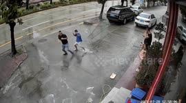 Father and son narrowly avoid being hit by falling window during typhoon in China