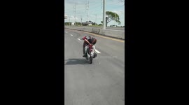 Motorcyclist Does Daring Stunts in Busy Traffic