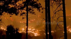 Lake Spokane wildfire glows at night in Lake Spokane, Washington, USA