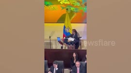 Colombian President slammed for using assistant as human laptop holder during speech