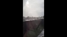 Gentle sun shower under partly sunny skies in South Boston, USA