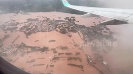 Plane passengers look in shock at the floods in northern Thailand