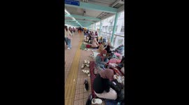 Hundreds of maids gather on footbridge for their day off in Hong Kong