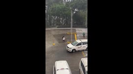 Pedestrian blown over while running through storm