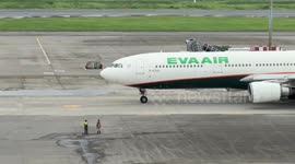 Airport workers wave as plane takes off in Taiwan