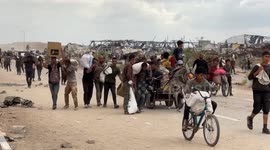 Palestinian woman collects spilled flour as aid shortages deepen in Gaza