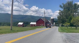 Farmer driving his tractor after fixing the drive belt in Pownal Vermont