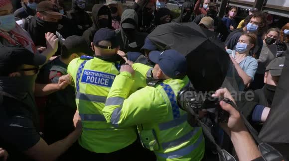 Clashes in Manchester as masked-up counter-protesters try to block Britain First from marching