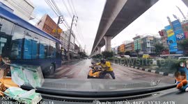 Scooter rider skids on wet road... then slips again when he tries to ride away