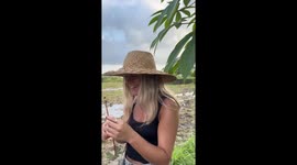 Tourist girls make necklaces from cassava leaves