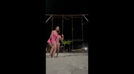 Swing collapses as couple pose on the beach