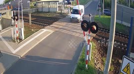 Train crashes into white van stuck on level crossing in Poland