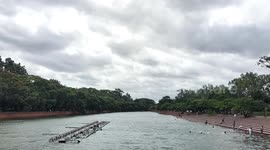Bangladesh: Children and youths bathe in the rain-filled lake at Chandrima Udyan in Dhaka