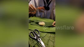 Schoolgirl shows how to pack hot food in banana leaf to keep fresh
