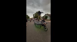 Man rides trampoline bicycle surrounded by cyclists in Boulder, USA