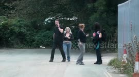 A shouting shopper converses with security staff, Kingsley village Cornwall, UK