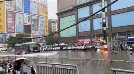 Bus pushes water waves over submerged motorcycle in Henan, China