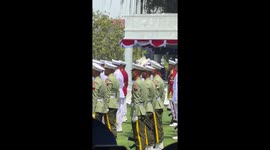 Soldier keeps his cool as bird rests on head during military parade