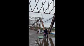 Singer dangles upside down from bridge for DIY music video