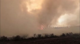 Firetornado rises from wildfire on hillside in Spain's Leon