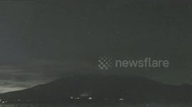 Meteor illuminates night sky over volcano in Japan
