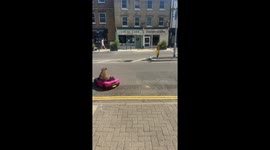 Dog enjoys a fun ride in a toy car in St Ives, England