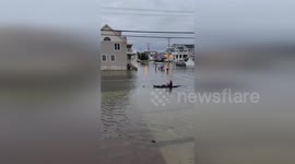Kayak Maneuvers Through Flooded Streets As Hurricane Erin Hits Avalon