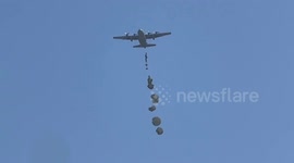 Palestinians rush for aid parcels airdropped over Gaza