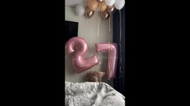 Curious cat grabs a balloon with her mouth and walks away unbothered