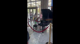 An Elderly Woman Playing The Piano