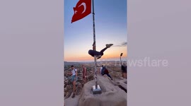 Tourist faces jail for pole dancing on flag in Turkey