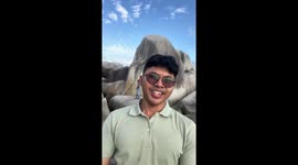 Tourist accidentally records beachgoer plunging into water behind him