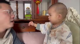 Baby's Hand Meets Dad's Mouth: A Surprising Encounter