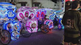 Row of Colorful Lighted Trishaws Brighten Melaka Street